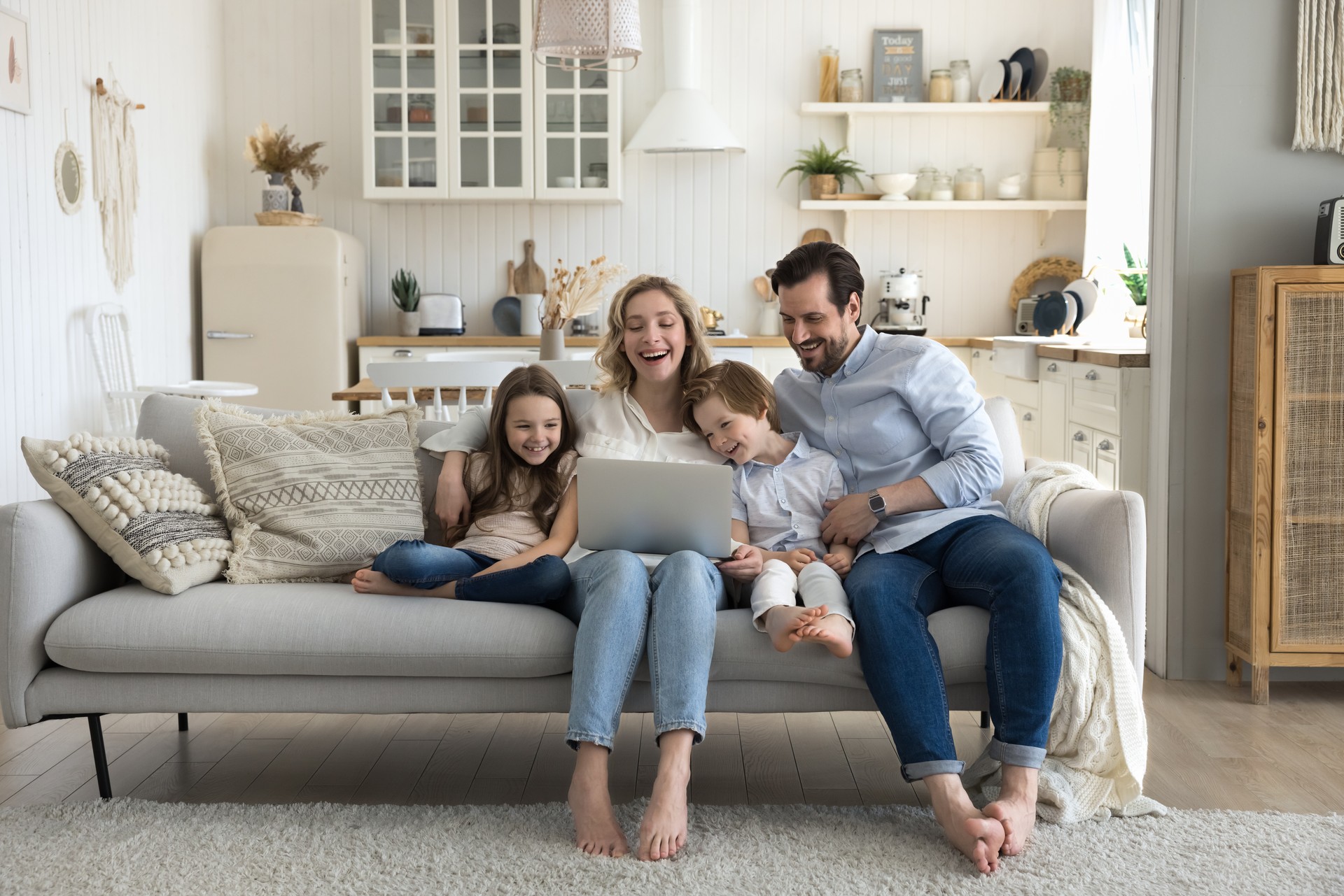 Two cheerful little kids, happy mom and dad enjoying leisure