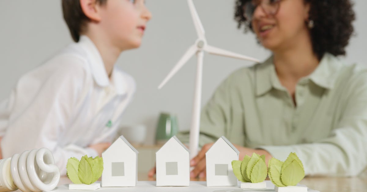 Children engage in learning about renewable energy with wind turbines and eco-friendly models in a classroom setting.